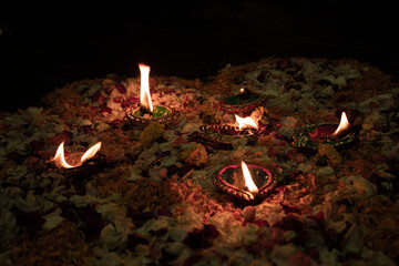 Floor decorated with diyas and flowers on the occasion of diwali