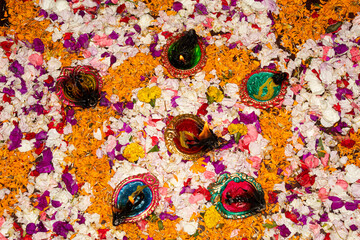 Floor decorated with diyas and flowers on the occasion of diwali