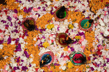 Floor decorated with diyas and flowers on the occasion of diwali