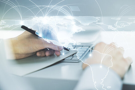 Double exposure of abstract digital world map with connections and hand writing in notepad on background with laptop, big data and blockchain concept