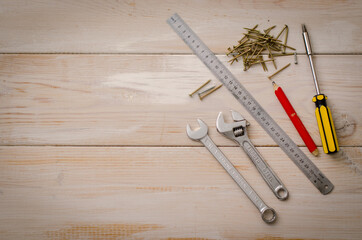 Professional repair tools for decoration and repair, set in a wooden background. Top view