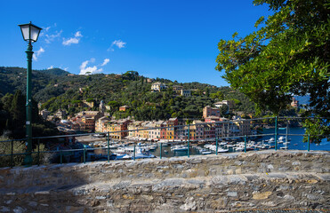 Obraz premium PORTOFINO, ITALY, SEPTEMBER 1, 2020 - Aerial view of Portofino, an Italian fishing village, Genoa province, Italy. A famous tourist place with a picturesque harbour and colorful houses.