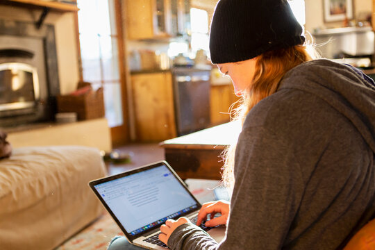 teenage girl using her laptop early morning