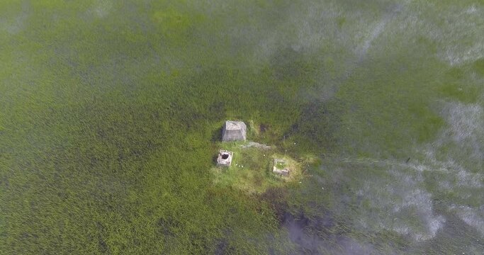 Ancient Archeological Ruins on Small Island in the Middle of Semi Dry Seasonal Lagoon shot from Above