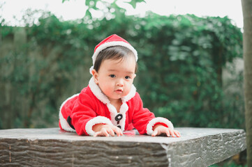 Little baby with Santa Claus  outfit on floor,celebrates Christmas,New Year's holidays.