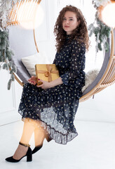 Beautiful brunette near the Christmas tree