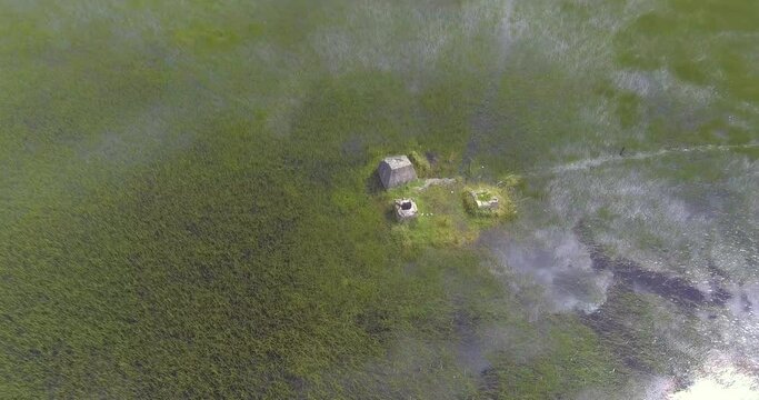 Ancient Archeological Ruins on Small Island in the Middle of Semi Dry Seasonal Lagoon shot from Above