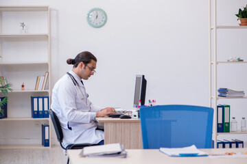 Young male doctor cardiologist working in the clinic