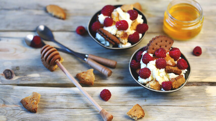 Delicious dessert with mascaraone, cookies and raspberries in a small dessert plate. Healthy sweets. Keto dessert.