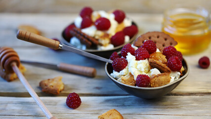 Delicious dessert with mascaraone, cookies and raspberries in a small dessert plate. Healthy sweets. Keto dessert.