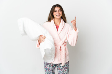 Young caucasian woman isolated on white background in pajamas and pointing up a great idea