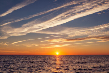 Sunset sky over the calm surface of the sea.