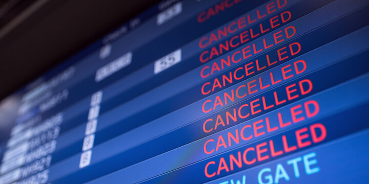 Flight information board displaying cancelled flights in international airport during COVID-19 pandemic 