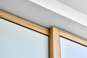 Modern wardrobe with finger pull design. Wooden wardrobe with light gray cabinet doors. Modern...