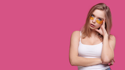 Woman with patches under eyes on pink isolate background. Tired girl with hangover