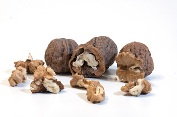 walnuts in close-up on white - composition of a group of walnuts - seasonal fruit