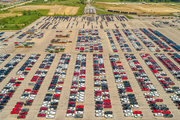 Overhead Aerial Shot of Large Vehicle Stock Lot at an Automobile Manufacturing Assembly Plant. 
