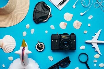 Top view of travel accessories set on blue background