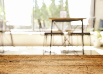 wood table on blur of cafe, coffee shop, bar, resturant, background - can used for display or montage your products
