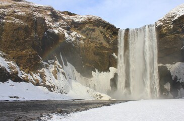 Fototapeta na wymiar Winter waterfall rainbow, Iceland