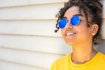 African American female young woman wearing blue sunglasses in summer sunshine
