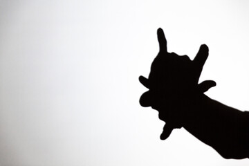 play shadow projected against a white background, a demon