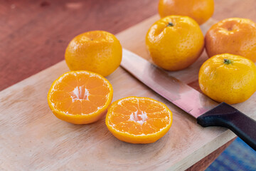 orange on wooden table close up