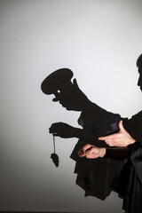 play shadow projected against a white background. a cook and mouse.