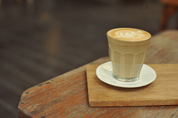 Cup of coffee on table in cafe - vintage style effect picture