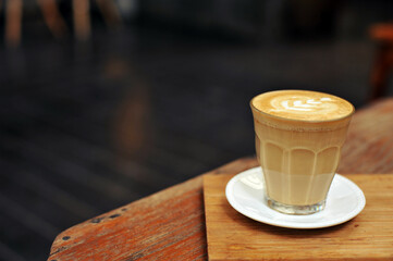 Cup of coffee on table in cafe - vintage style effect picture