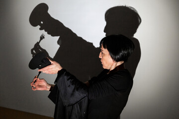 play shadow projected against a white background, a cook