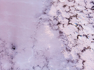 Amazing forms of land surface made of water and salt, nature abstract background, aerial view. Pink extremely salty Kuyalnik Liman in Odessa, Salty layer on the bottom of Shallow Lake