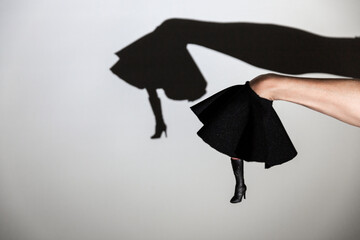 play shadow projected against a white background, legs of a dancer