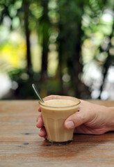 Cup of coffee on table in cafe - vintage style effect picture