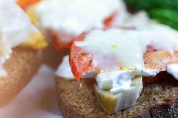 Fresh sandwich with bacon, tomato and cheese. Close up photo. Soft focus.
