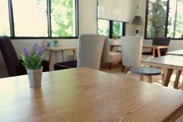 wood table on blur of cafe, coffee shop, bar, resturant, background - can used for display or montage your products
