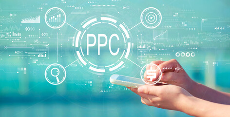PPC - Pay per click concept with person holding a white smartphone