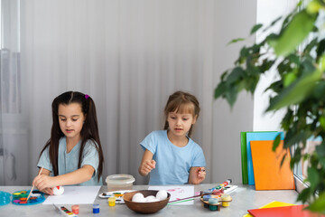 two little girls with brush painting on table, education, watercolor, drawing, Creativity concept.