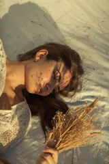 Portrait of a woman in white dress on white background and in nature