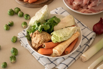 Ingredients for preparing a vegetable broth or soup - carrots, Savoy cabbage, onions, cauliflower, celery root, parsley root and other