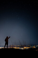 man in starry sky pointing at comet neowise