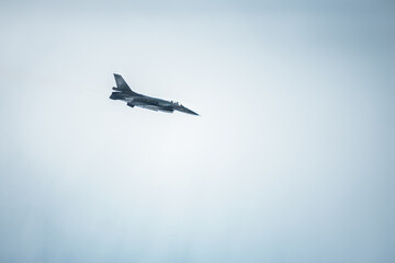 fighting jet f-16 in the cloudy sky