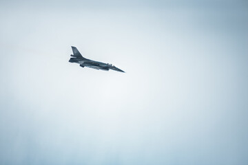fighting jet f-16 in the cloudy sky