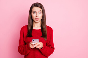 Photo of lovely young lady hold cellphone confused scared look camera wear red pullover isolated pink color background