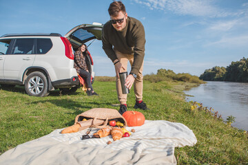 couple having picnic date at river beach