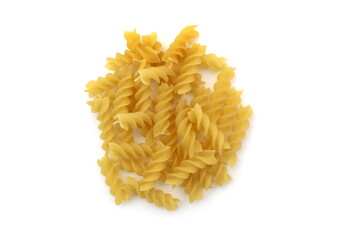 Spiral pasta lie in a heap on a white background