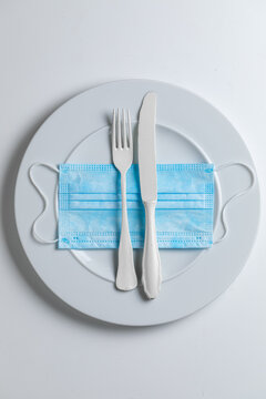 Medical Mask And Plate As Symbol Of Food Industry Restrictions