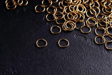 Jewelry for piercing on dark background. Stock Image macro. Top view.