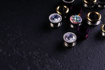 Jewelry for piercing on dark background. Stock Image macro. Top view.