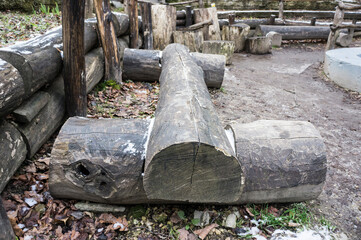 Obraz premium Bench made of a whole old log, a place to relax in the woods